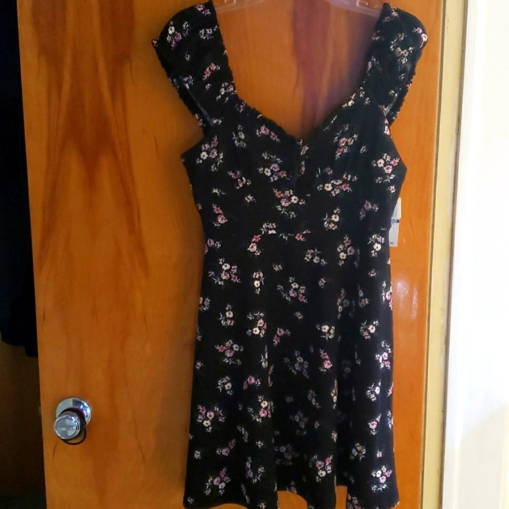New with tags dress from Ultra Flirt.  Size Medium Black with flowers.